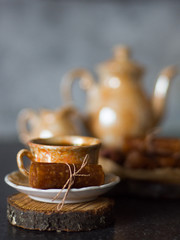 Apple fruit candy with a cup of coffee close up on a wooden stand with soft blur background