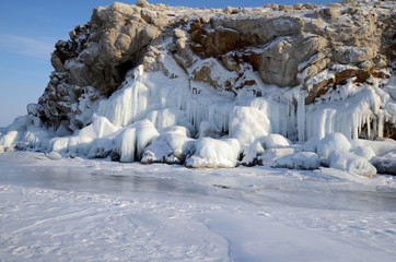 Ice blockes and walls on frozen rocks and stones, formed during freezing of lake Baikal