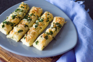 Cheese sticks with herbs on a gray plate