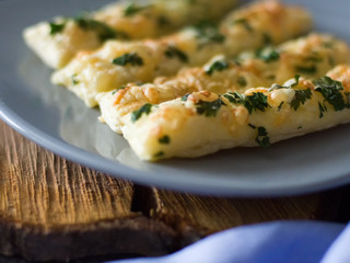 Cheese sticks with herbs on a gray plate