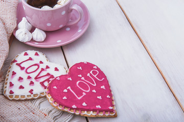 Valentine's day breakfast. Delicious coffee and cookies on a white wooden table. Start a romantic and lovely day. Top view.
