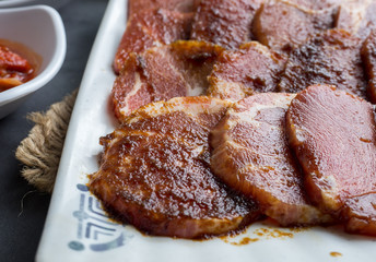Set of slice raw pork ready to grill korean style, include slide food with vegetable and rice.