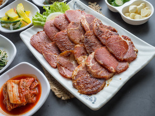 Set of slice raw pork ready to grill korean style, include slide food with vegetable and rice.