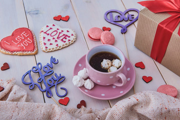 Valentine's day breakfast. Delicious coffee and cookies on a white wooden table. Start a romantic and lovely day. Top view.