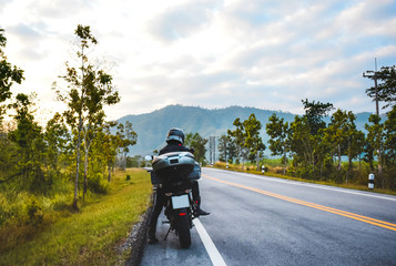 Obraz premium man travel by motorcycle,biker and landscape
