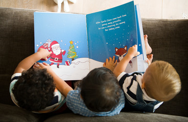 Young kids reading a Christmas story together
