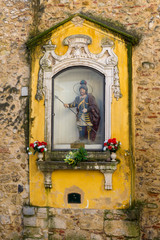 LISBON, PORTUGAL - NOVEMBER 21, 2018: niche with an image of St. George at the entrance of the castle of the same name