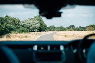 Countryside view through car windscreen