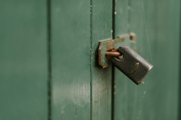 Padlock on a green gate