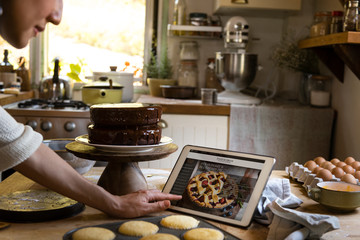 Woman reading baking recipe on a tablet