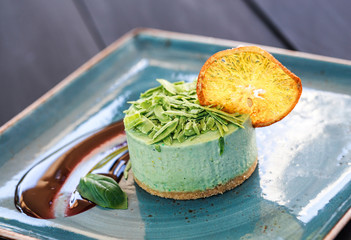 Delicious mint cheesecake with candied fruit and jam on plate