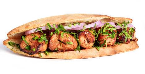 Grilled meat in sandwich with onion and greens on white background. Shashlik or Shish kebab popular in Eastern Europe. Hot meat dishes