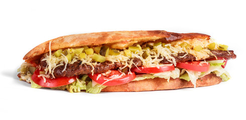 Sandwich from fresh pita bread with fillet grilled beef, lettuce, slices of fresh tomatoes, pickles and cheese on white background