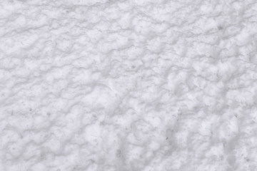 Texture of wet snow on the ground, close-up view. Snowdrift melting.