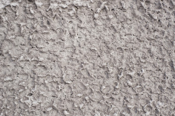 The texture of the walls with plaster under a layer of cement, uneven cement wall coating