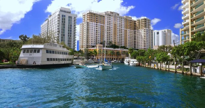 Panorama of Fort Lauderdale harbor canals with sailing boats, palm trees and skyline of skyscrapers condominiums in Florida, 4K