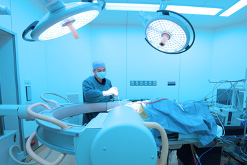 veterinarian surgery in operation room take with art lighting and blue filter