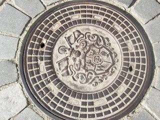 Fototapeta na wymiar old manhole cover