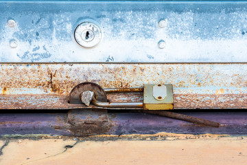 Old padlock on a rolling shutter door