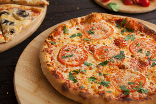 pizza, fresh tomato pizza with mozzarella and cheese. Italian pizzeria. Fresh pizza on the kitchen table