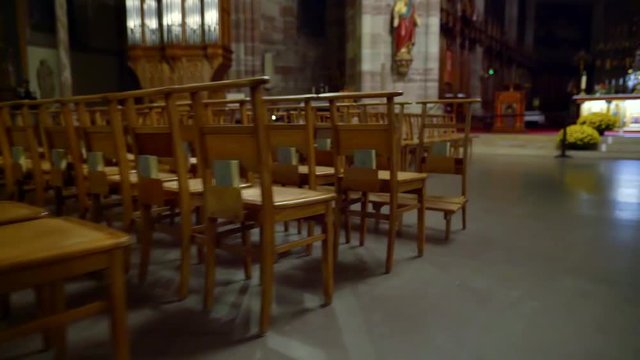 circled on the Steadicam along the empty Cathedral. wooden chairs for prayer in a Catholic Church