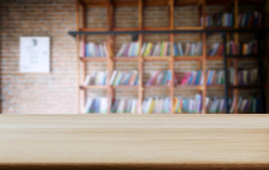 Selected focus empty old wooden table and .Library or Bookstore blur background with bokeh image. for your photomontage or product display