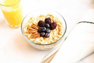 Oatmeal and fresh fruit breakfast; healthy eating concept
