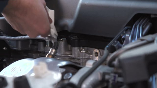 Service car at home before long road trip.  Check engine oil level  by dipstick