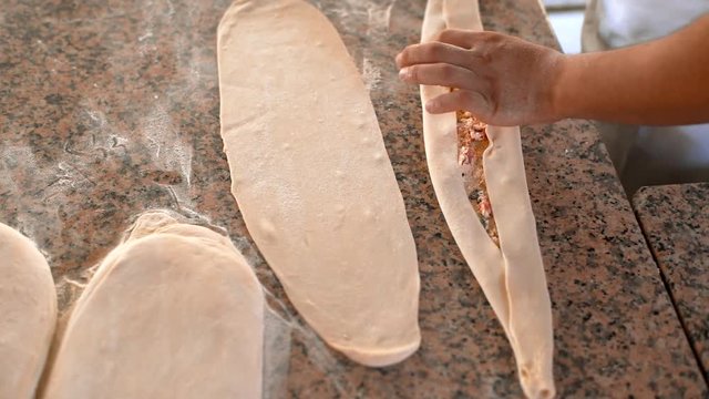 A man prepares delicious traditional Turkish cakes Pida. 4k