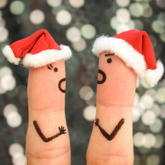 Fingers art of couple celebrates Christmas. Concept of a man and woman yelling at each other in New...