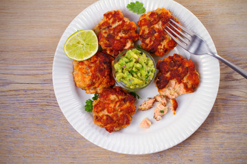 Salmon burgers with avocado salsa and lime. Salmon cakes. Fish patties. overhead, horizontal