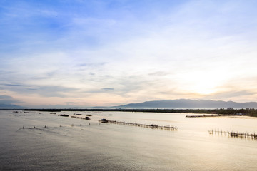 Fototapeta na wymiar Sunrise Fish farms, Fish cages at The estuary Laem Sing, Chanthaburi ,Thailand.