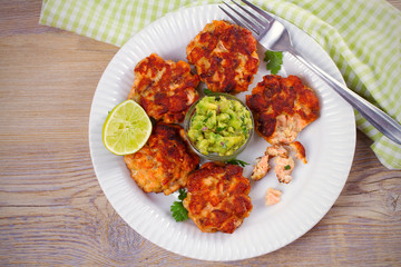 Salmon burgers with avocado salsa and lime. Salmon cakes. Fish patties. overhead, horizontal