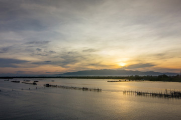 Obraz na płótnie Canvas Sunrise Fish farms, Fish cages at The estuary Laem Sing, Chanthaburi ,Thailand.