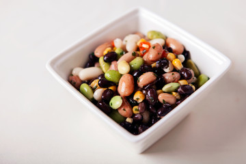 Vegan bean salad, served in a white bowl.
