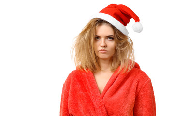Sad sleepy girl in a bathrobe in New Year's hat. Wants to sleep. New Year. Christmas. Not enough sleep. Isolated on white background