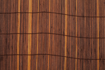 Sunburned bamboo matt background. Texture of asian mat from brown yellow bamboo. Super macro, close up image