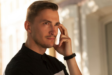 portrait of a serious young man. a young brunet male wondered, emotion, concentration and tension,
young man looking at the camera, serious look