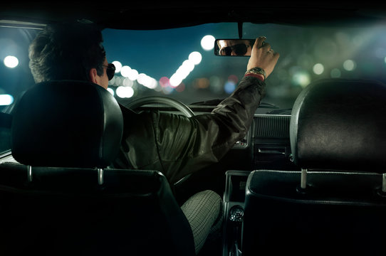 Man wearing leather jacket sitting in car