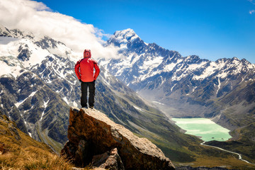 Tourism vacation and travel. Happy free tourist man standing outstretched up looking at river and...