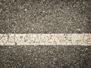 white lines on an asphalt road-narrow depth of field