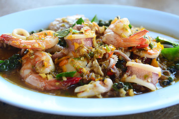 Thai Fried stir spicy sea food in white dish.