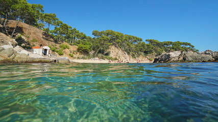 Spain Costa Brava beach with a fisherman hut near Palamos seen from water surface, Cala Estreta,...