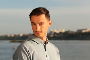 portrait of a serious young man. a young brunet male wondered, emotion, concentration and tension,
young man looking at the camera, serious look