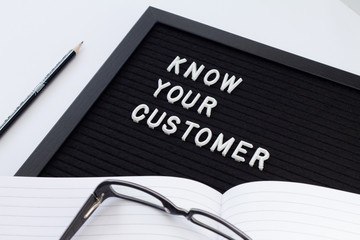 Know Your Customer - business concept, white text message on black board. Idea of business identification and finance safety. Cyber crime.