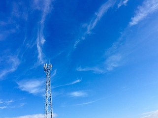 Obraz premium Communication tower on blue sky background