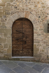 Tuscan medieval village, small door with an antique lock