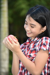 Happy Beautiful Filipina Juvenile With An Apple