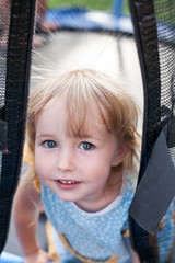 cute toddler girl on trampoline