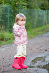 Naklejka premium cute toddler girl in gumboots